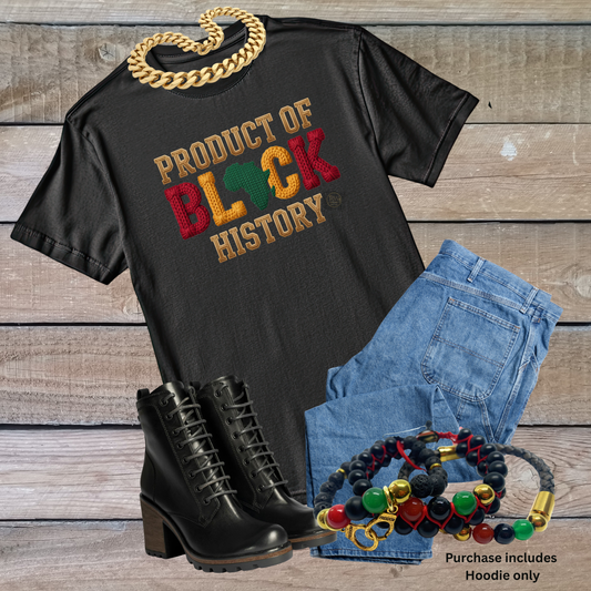 Black t-shirt with 'Product of Black History' text, denim shorts, black boots, and colorful beads on a wooden surface.