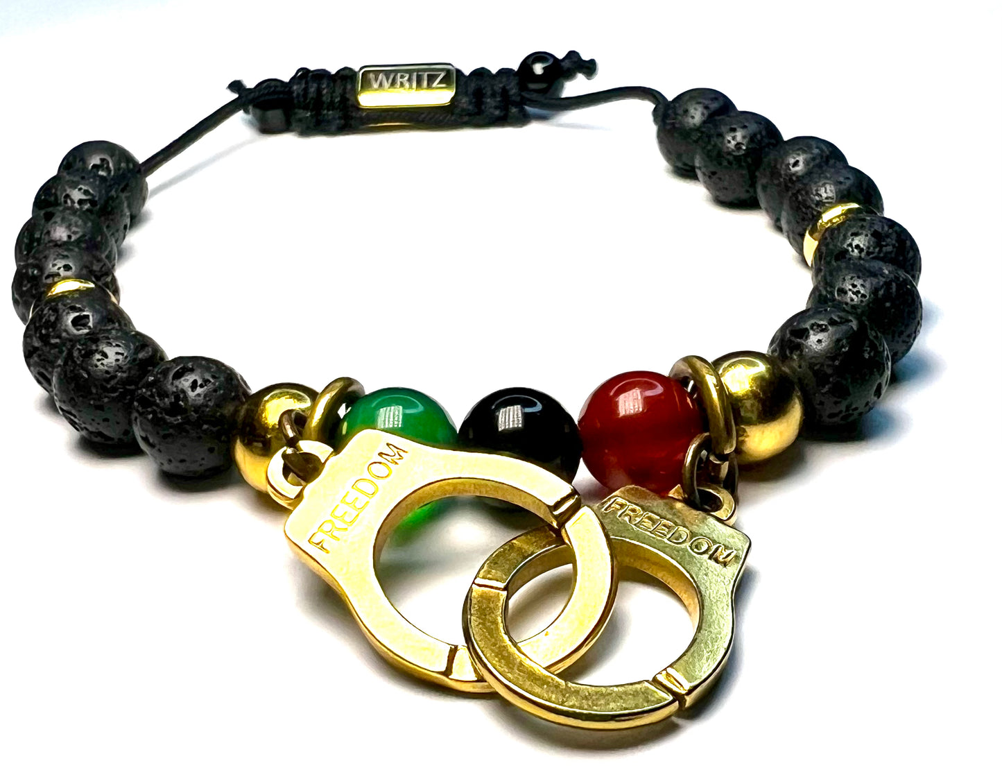 Bracelet with black beads, gold handcuffs, and colored stones on a white background