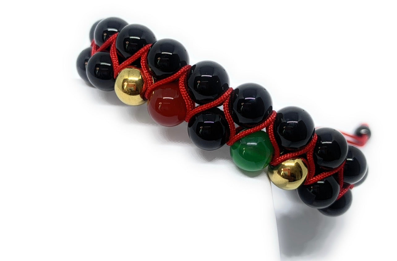 Multicolored beaded bracelet with black, red, gold, and green beads on a white background
