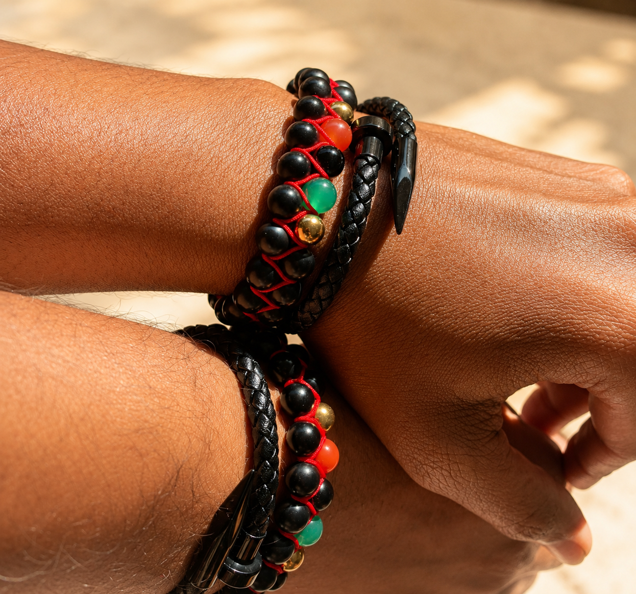 Close-up of a wrist wearing two braided bracelets with beads.