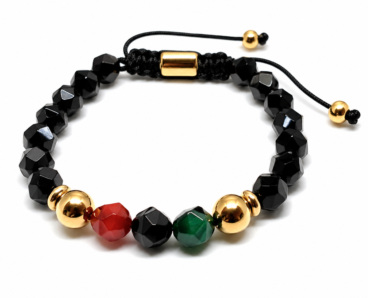 Black beaded bracelet with gold, red, and green beads on a white background