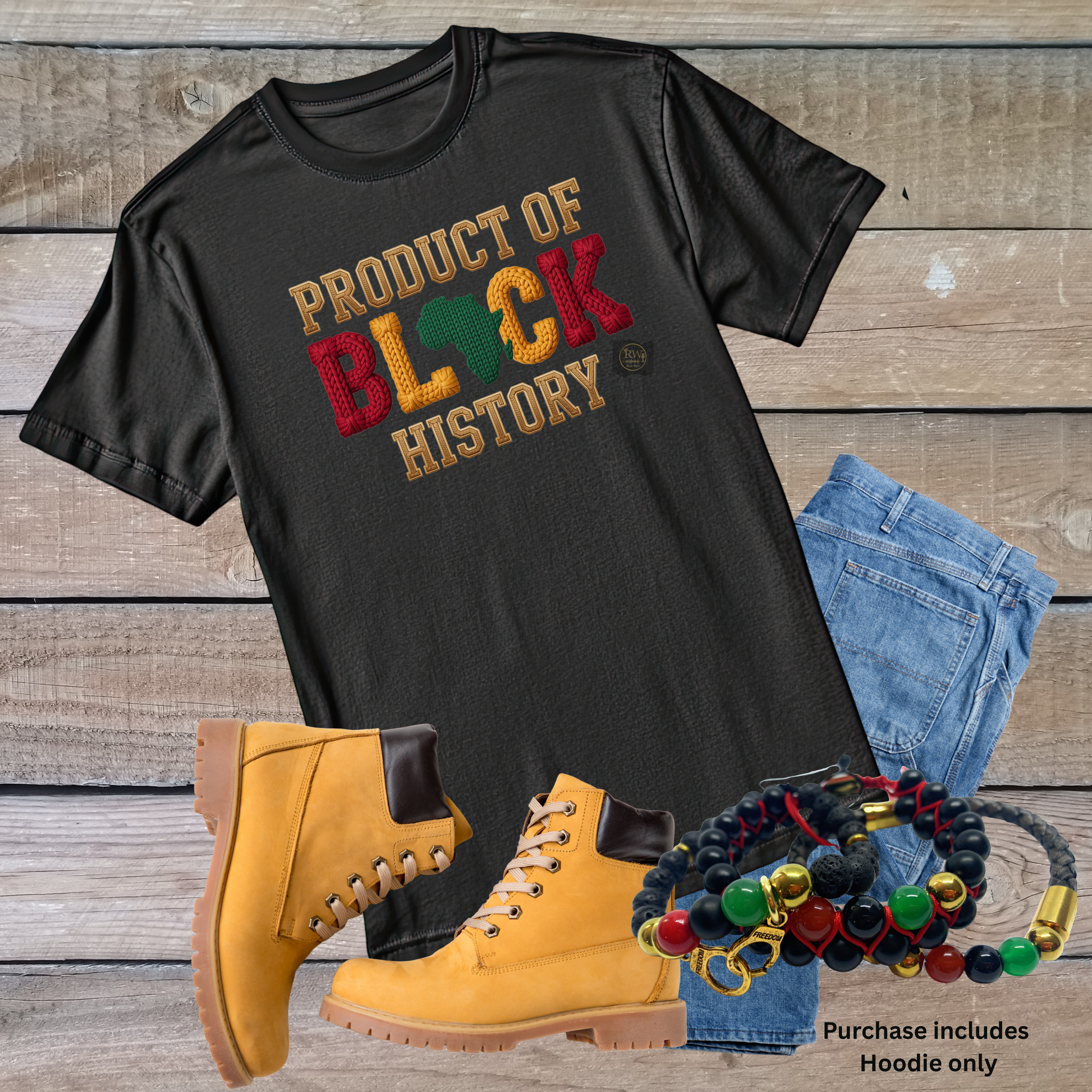 Black t-shirt with 'Product of Black History' text, yellow boots, blue jeans, and colorful bracelets on a wooden surface.