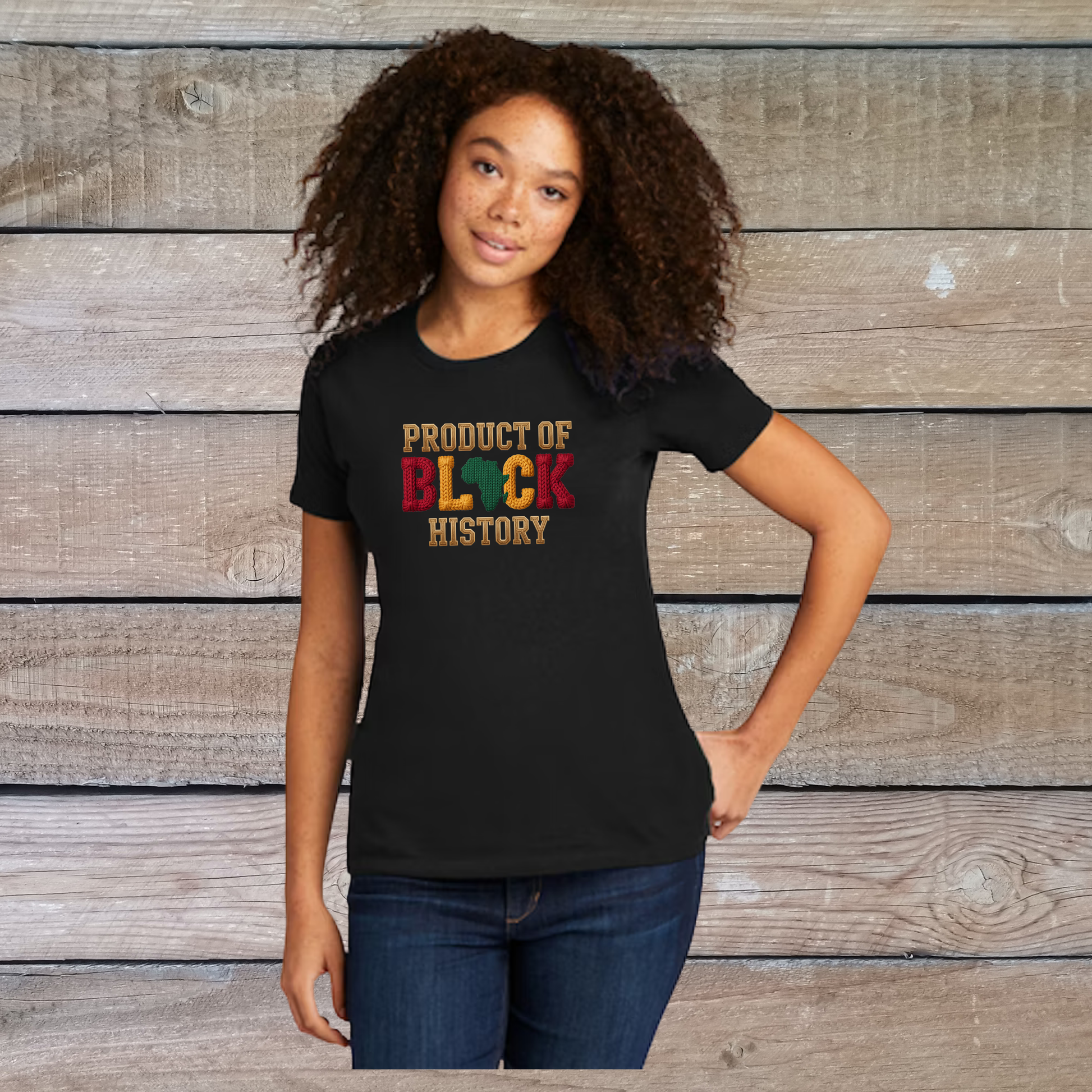 Black t-shirt with text on a wooden surface, colorful beaded bracelet on the side.