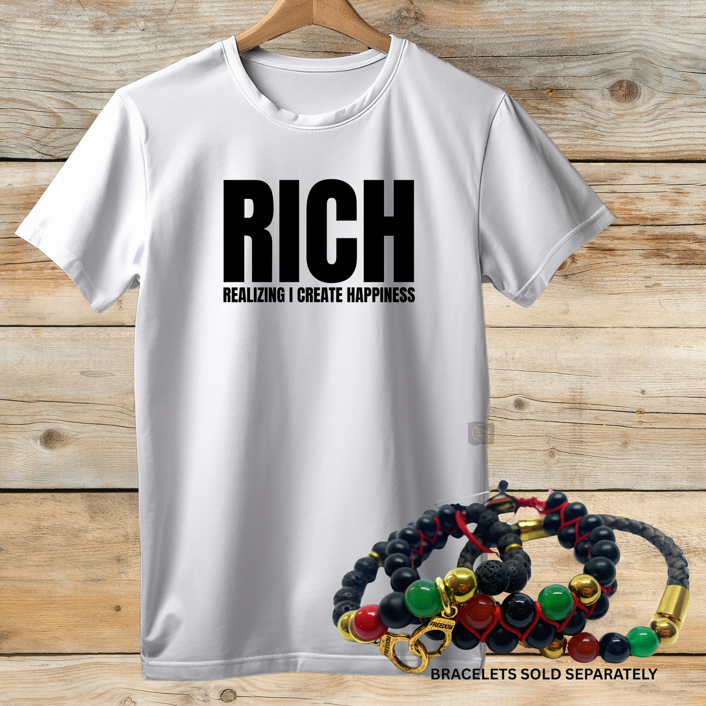 White t-shirt with 'RICH' text and bracelets on a wooden background