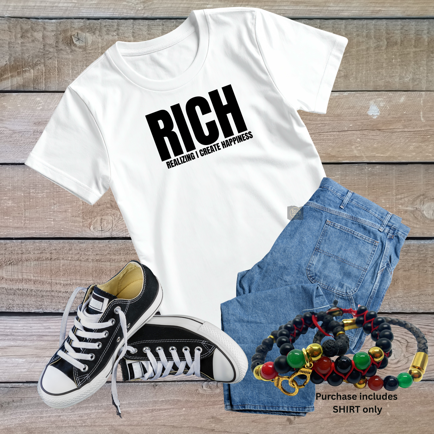 White t-shirt with 'RICH' text, black sneakers, denim shorts, and colorful bracelets on a wooden surface.