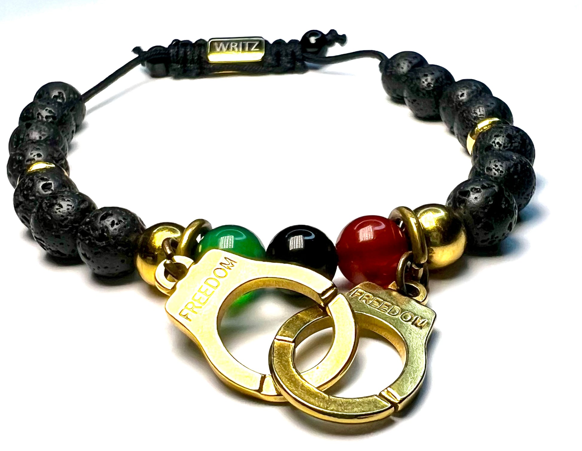 Bracelet with black beads, gold handcuffs, and colored stones on a white background