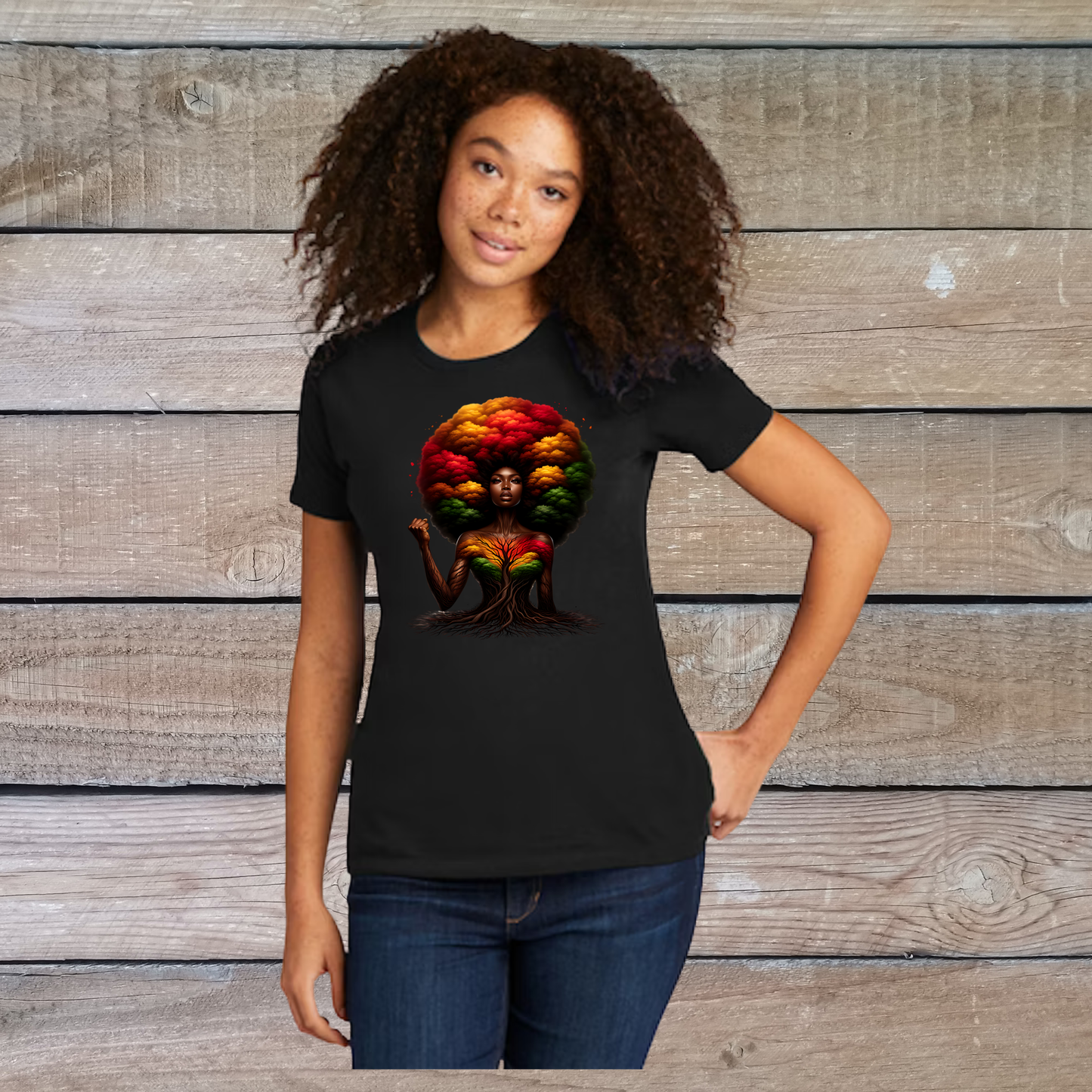 Person wearing a black t-shirt with a colorful graphic design against a wooden background