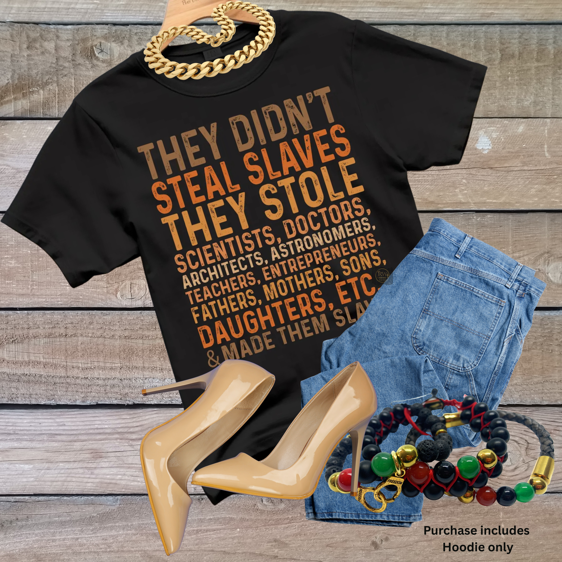 Black hoodie with text, denim shorts, high heels, and jewelry on a wooden surface